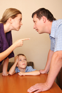 Photo of parents arguing in front of their child