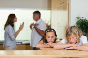 Photo of parents arguing in front of their children