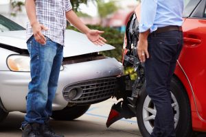 Two Drivers Arguing After Traffic Accident Crop Shot Of Crash.