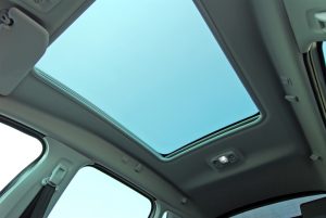 photo large sunroof inside car, sky and clouds