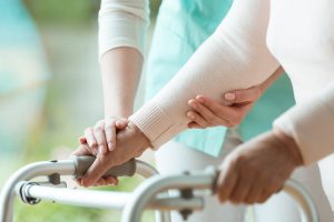 elderly person using walker in nursing home