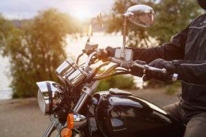 Biker riding on motorcycle near the river