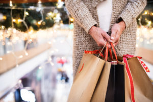 senior woman with paper bags doing Christmas holiday shopping. 