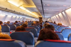 Interior of airplane with passengers on seats waiting to taik off