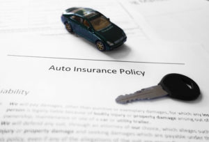Auto insurance policy with key and miniature car