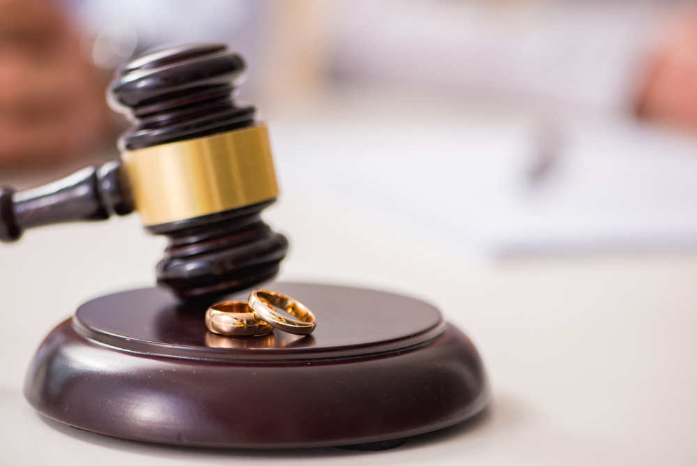 Divorce Lawyer Rockland County, NY with wedding rings and gavel on a desk