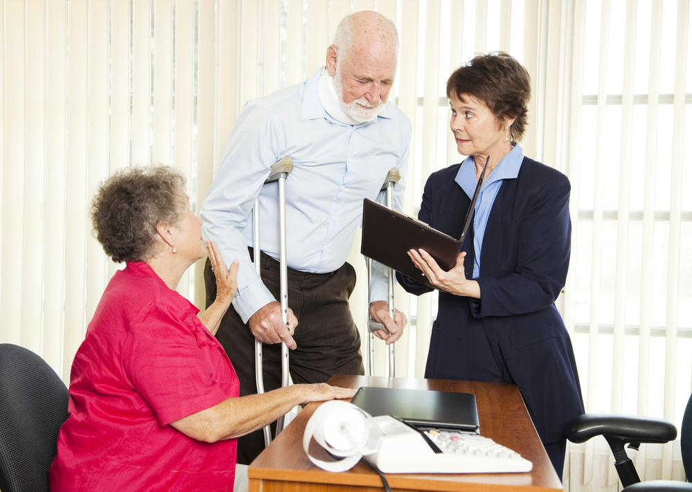 Nursing Home Lawyer Rockland County, NY with an elderly injured man with supportive wife talking to a lawyer