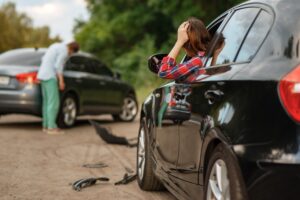 Car Accident Lawyer Rockland County, NY with a woman holding her head after an accident